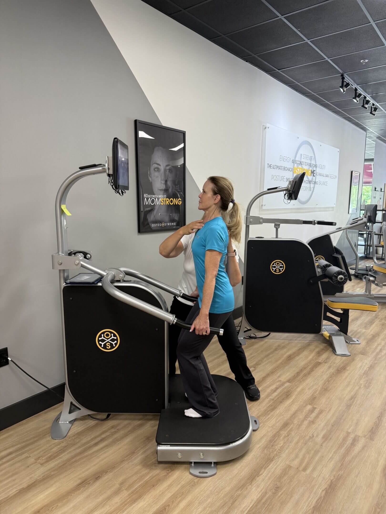 Person using exercise machine in gym.