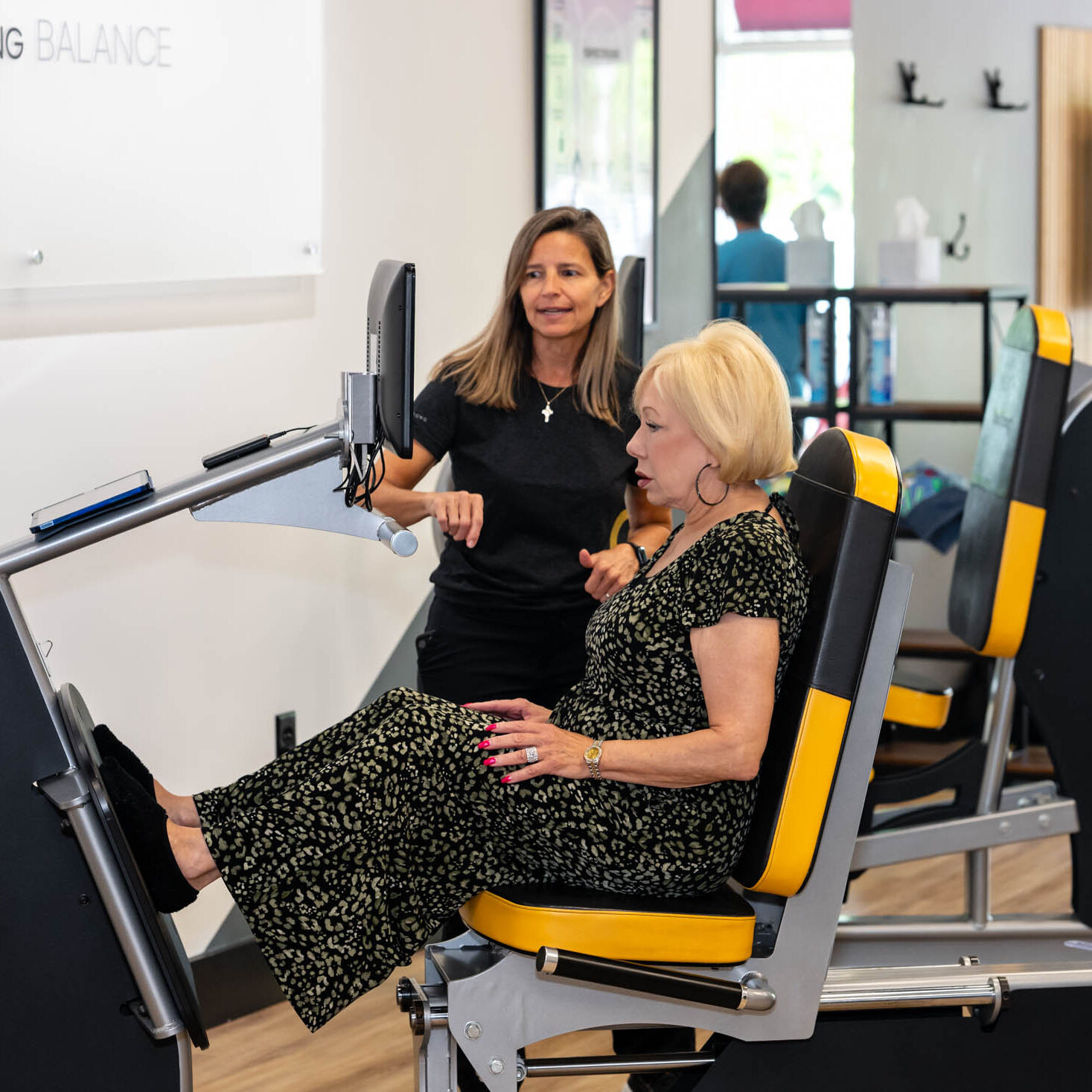 Woman exercising on leg press machine.