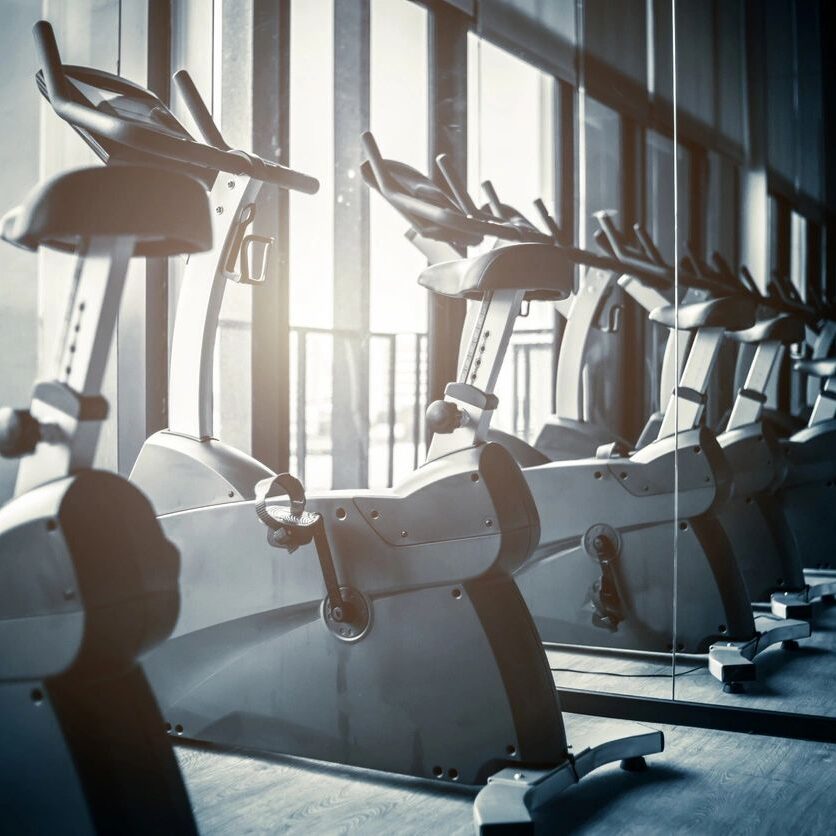 Row of stationary bikes in a gym.